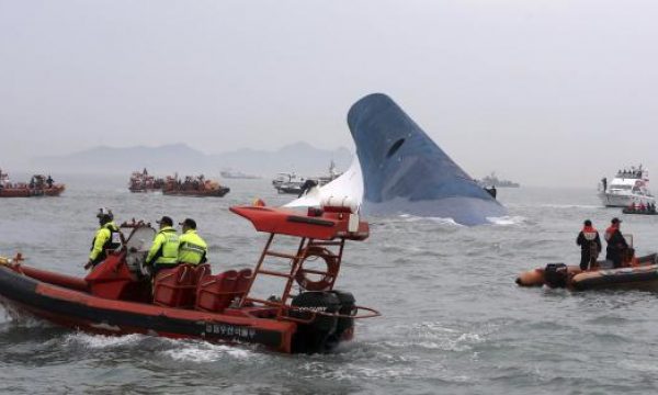 Part of South Korean passenger ship "Sewol" that has been sinking is seen as South Korean maritime policemen search for passengers in the sea off Jindo