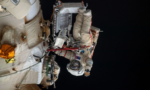 (April 18, 2022) - Cosmonaut Oleg Artemyev waves to the camera while working outside the Nauka multipurpose laboratory module during a spacewalk that lasted for six hours and 37 minutes to outfit Nauka and configure the European robotic arm on the International Space Station's Russian segment.