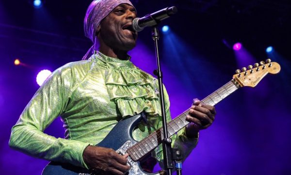 Otis stokes from the band lakeside playing a guitar and wearing a green shirt